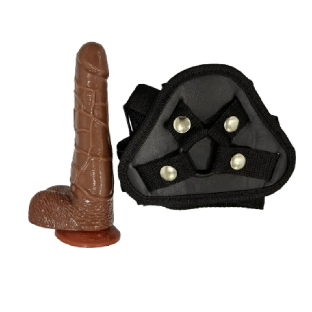 Sexual product with brown dildo and black belt on a white background