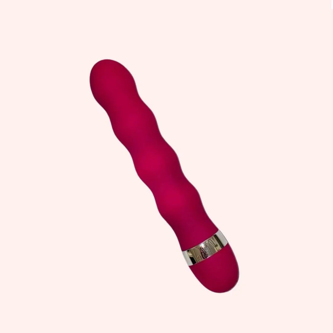 Pink vibrator with a metallic ring on a white background