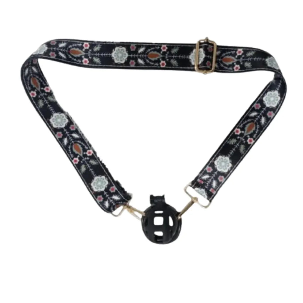 Floral-patterned belt with black plastic chastity cage on a white background
