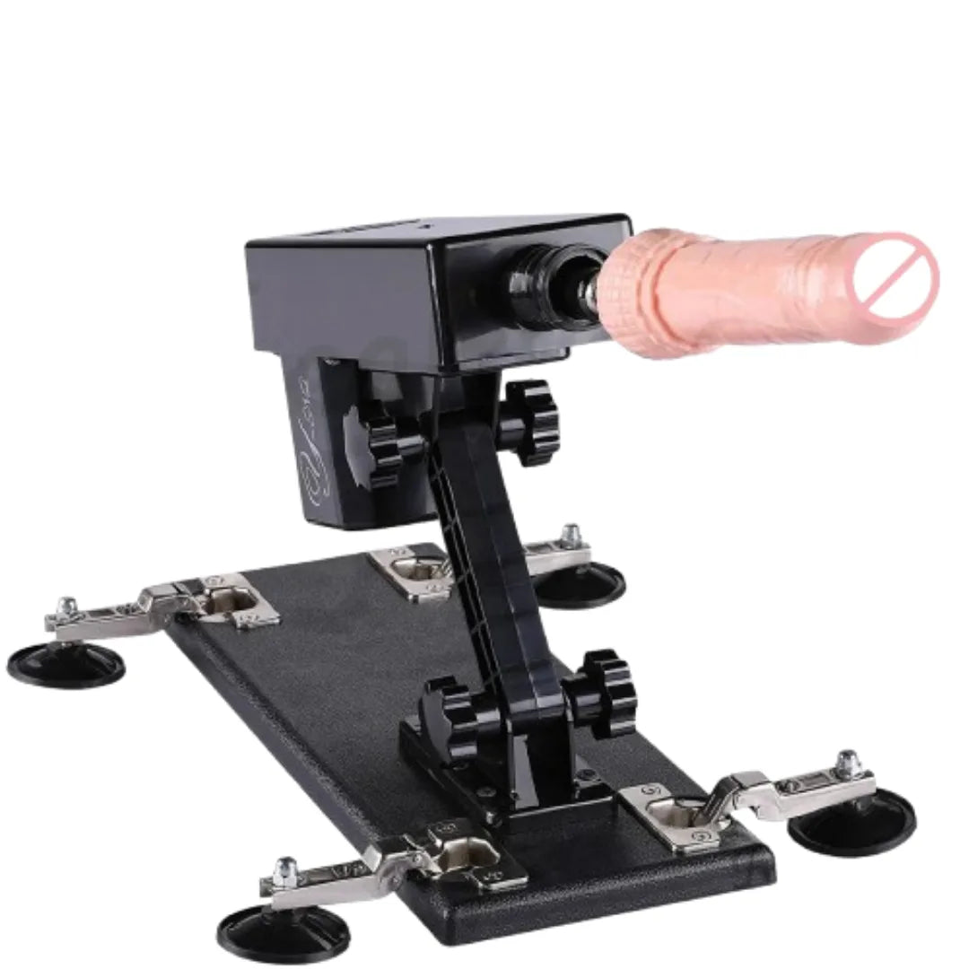 Black mechanical device with a pink dildo on a white background