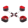 Black and red leather cuffs with a central chain on a white background