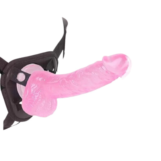 Pink dildo with black straps on a white background