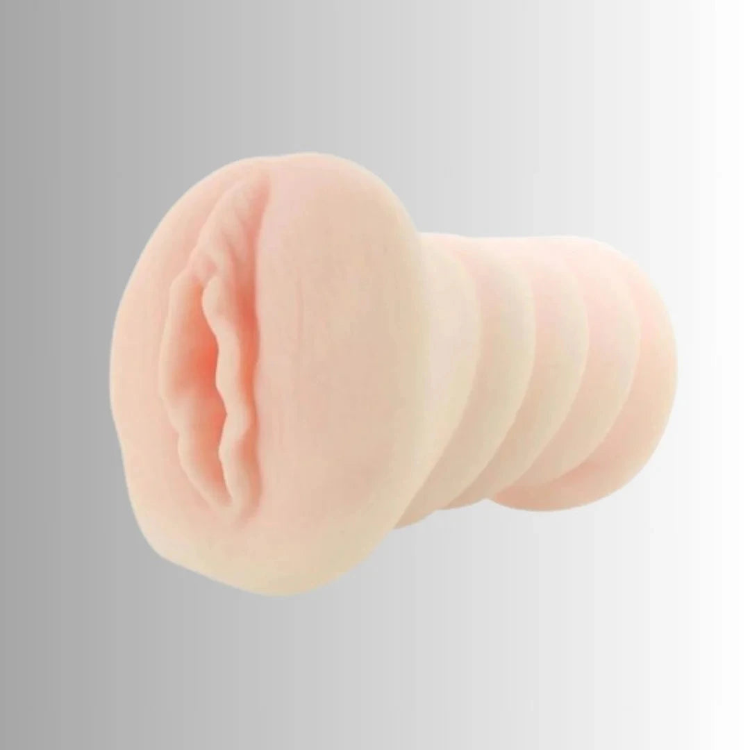 Close-up of a silicone male masturbator on a gray background