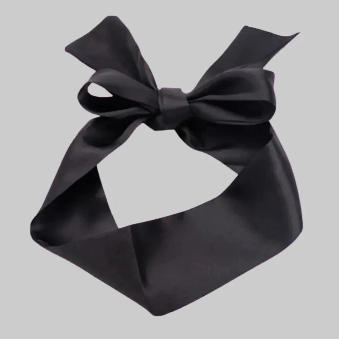 Black satin bow on a light gray background