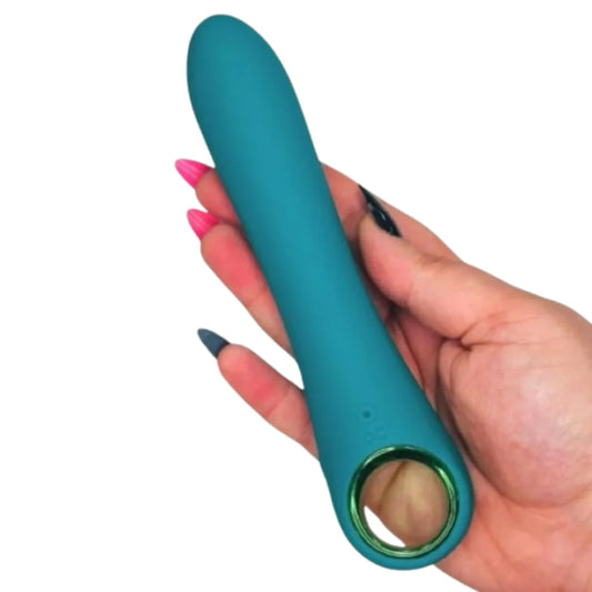 Teal silicone Vibrator  held in a hand with pink nail polish on a white background
