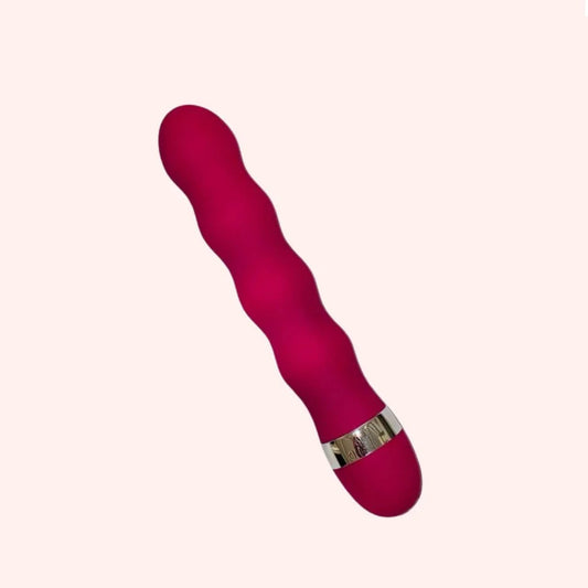 Pink vibrator with a metallic ring on a white background