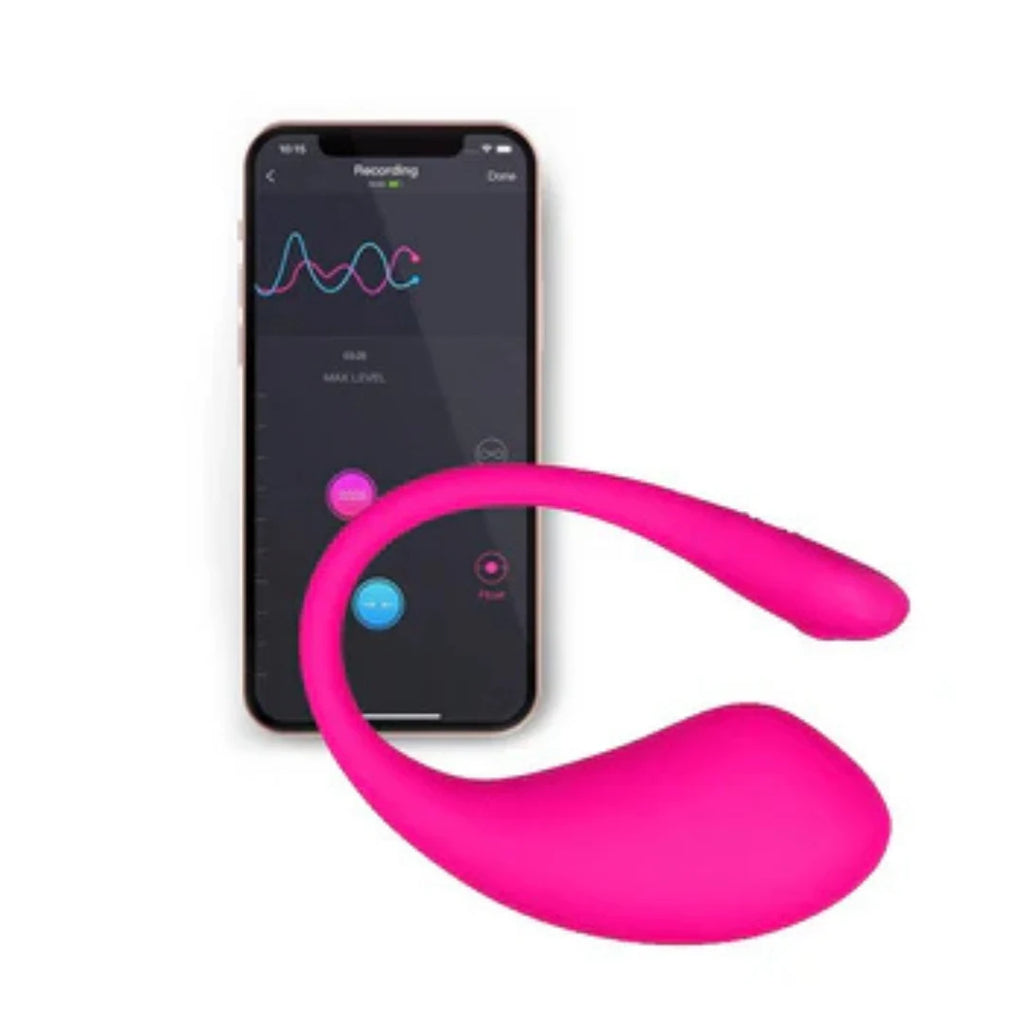 Pink silicone device next to a smartphone displaying app